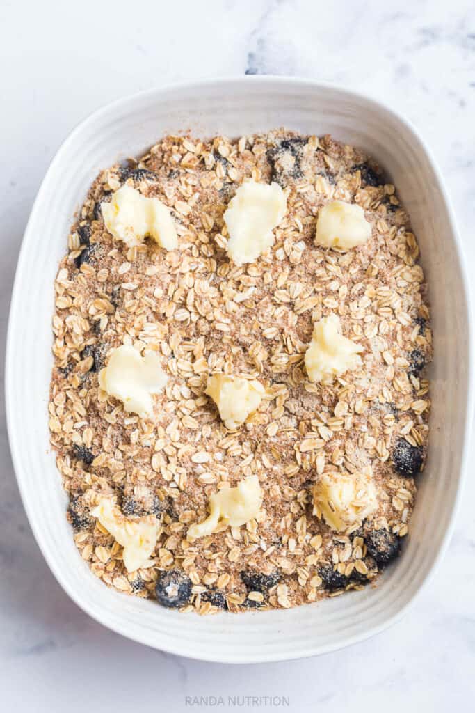 pats of butter over a oat topping dessert