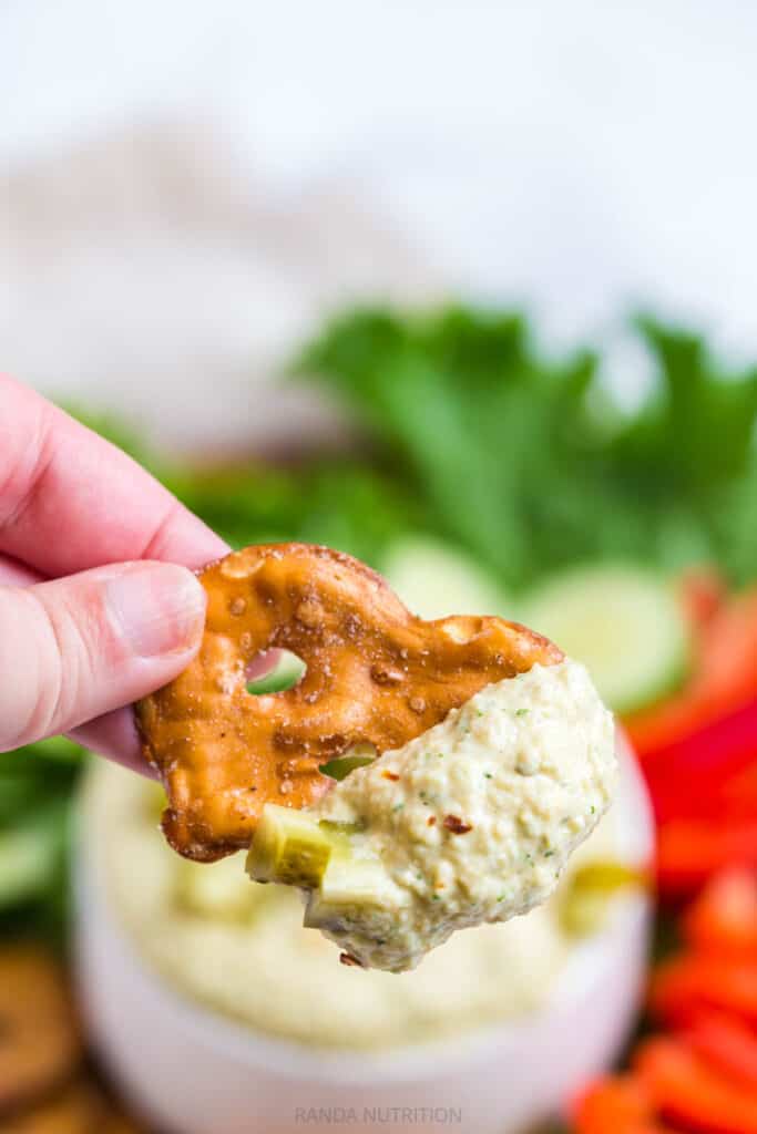 Pretzel chip dipped in hummus