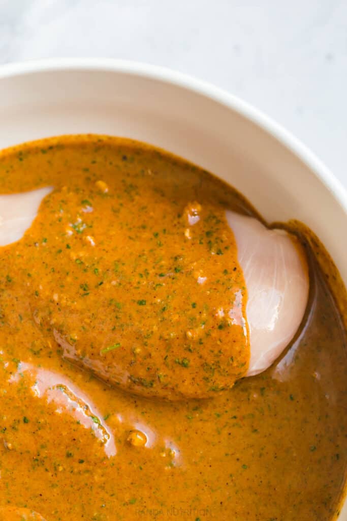 marinating chicken in a bowl