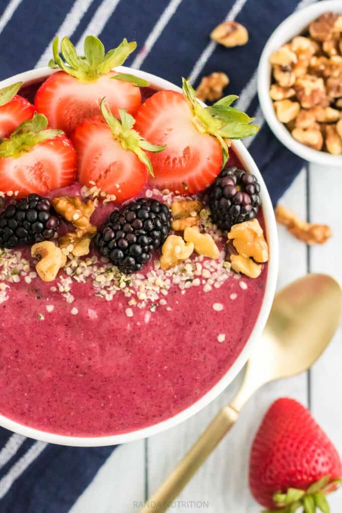 close up of berries on top of a smoothie bowl