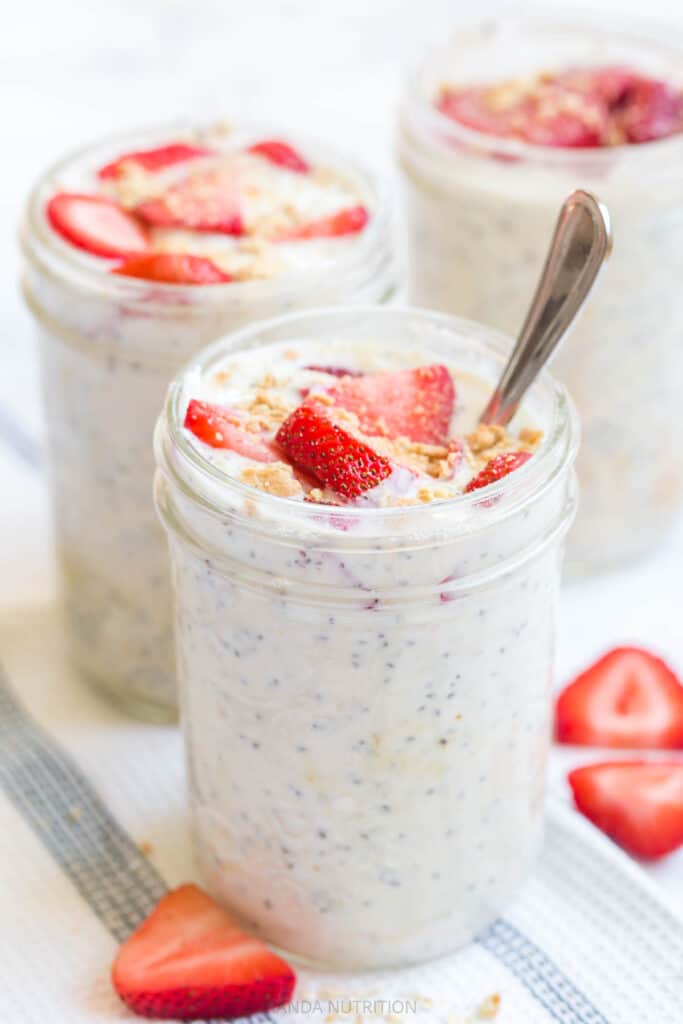 strawberry cheesecake overnight oats with a spoon
