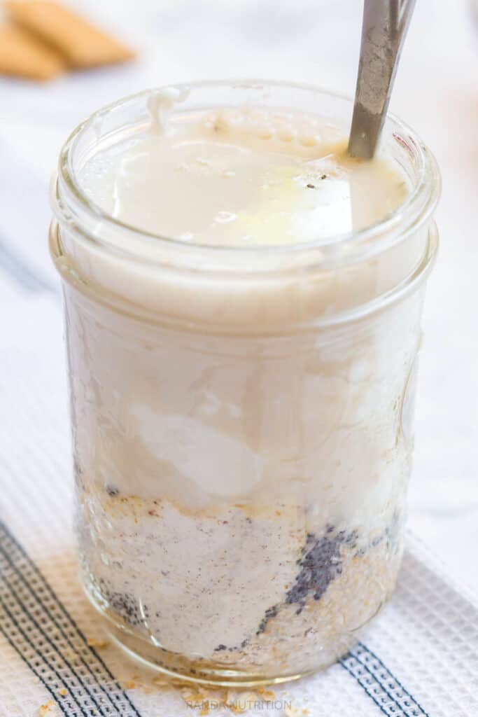 mixing overnight oats in a mason jar with chia seeds and protein powder
