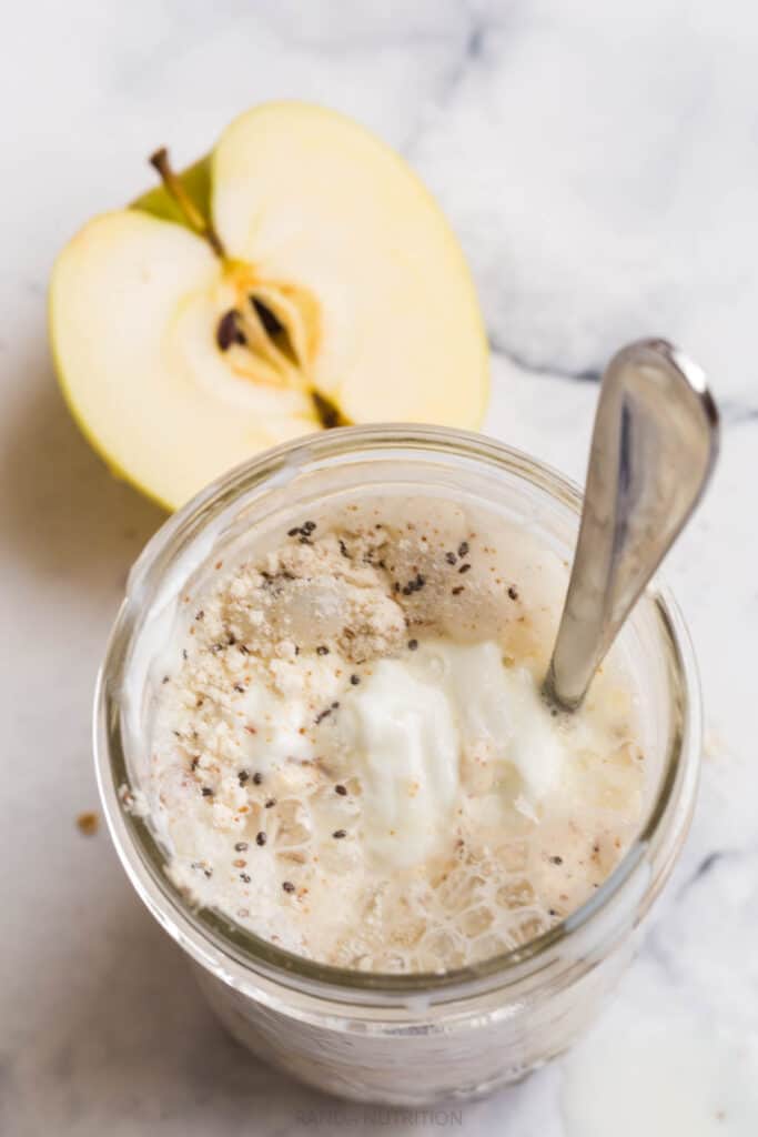 mixing together greek yogurt, protein powder, milk to make a high protein overnight oats