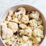 tossing cauliflower in a sesame soy marinade