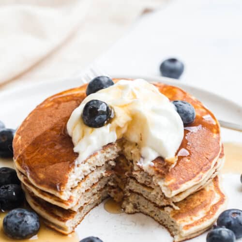 protein cottage cheese pancakes topped with blueberries and greek yogurt