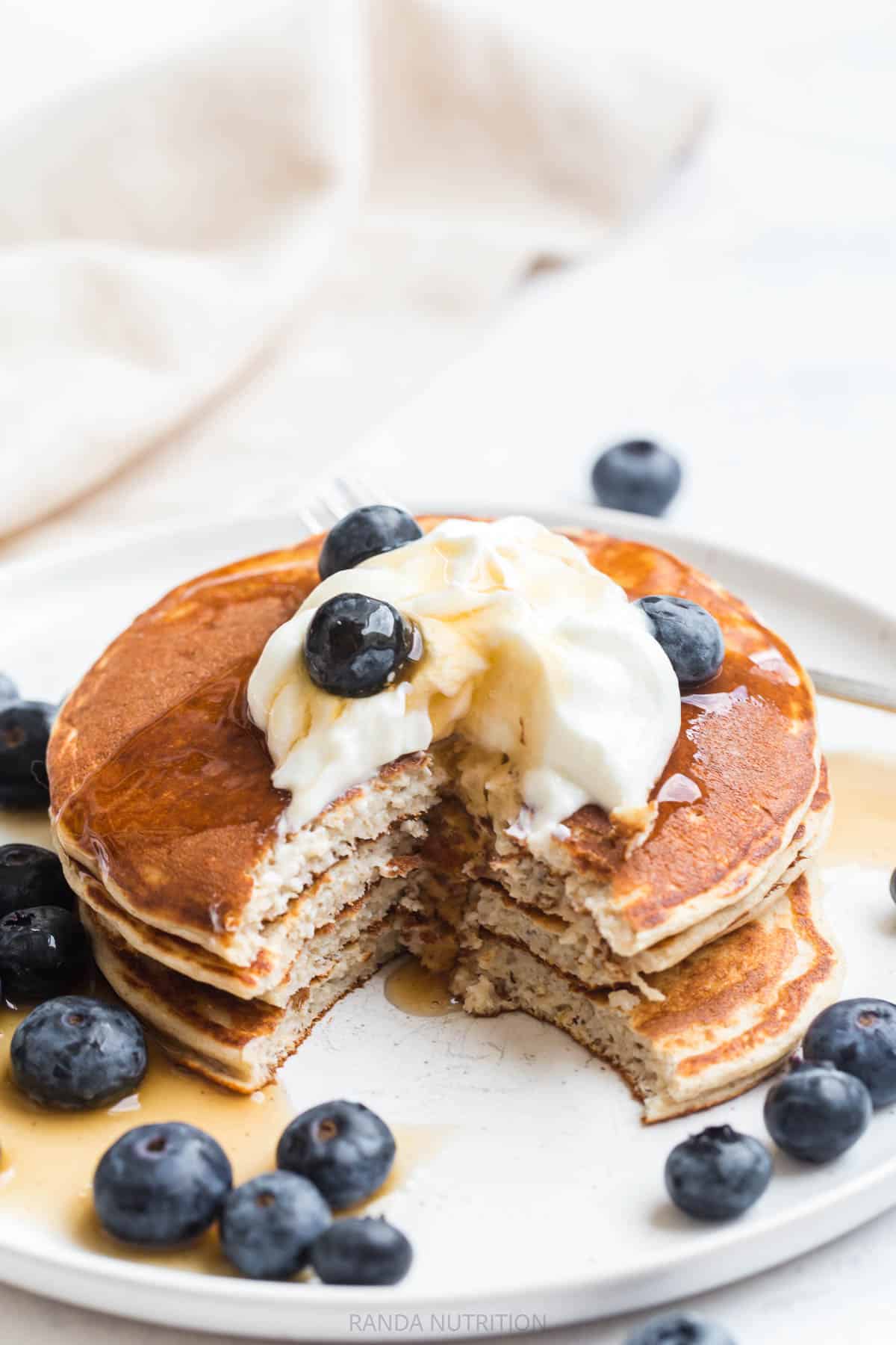 protein cottage cheese pancakes topped with blueberries and greek yogurt