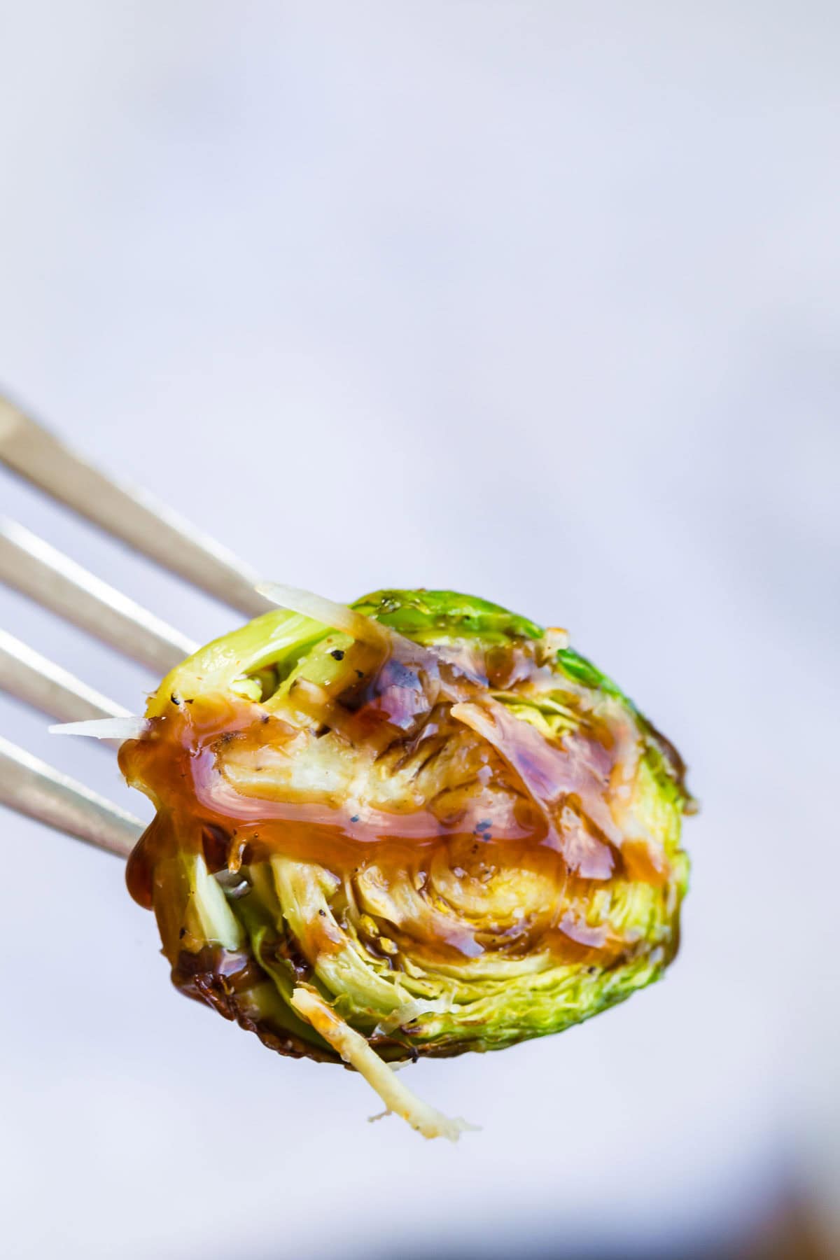 crispy brussels sprout with balsamic glaze on a fork