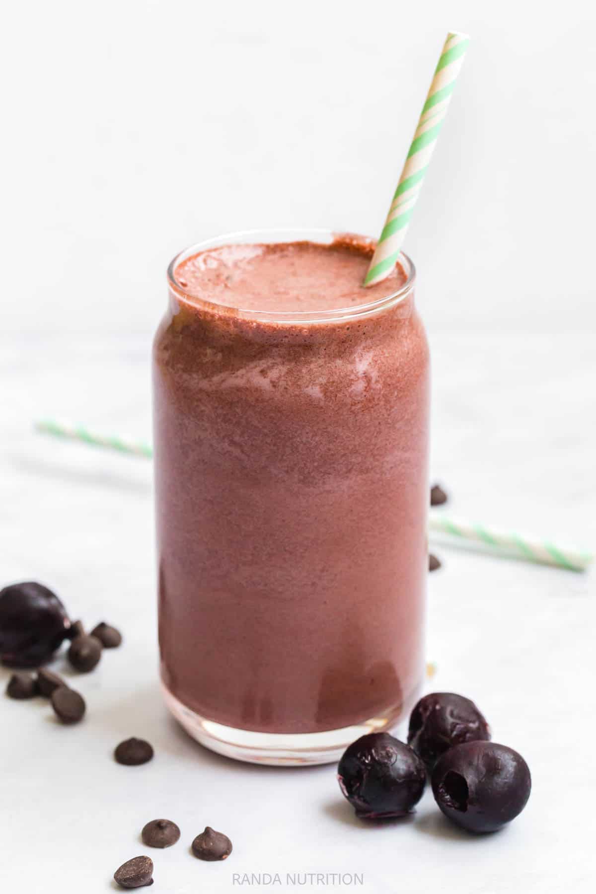 chocolate cherry smoothie with a green straw