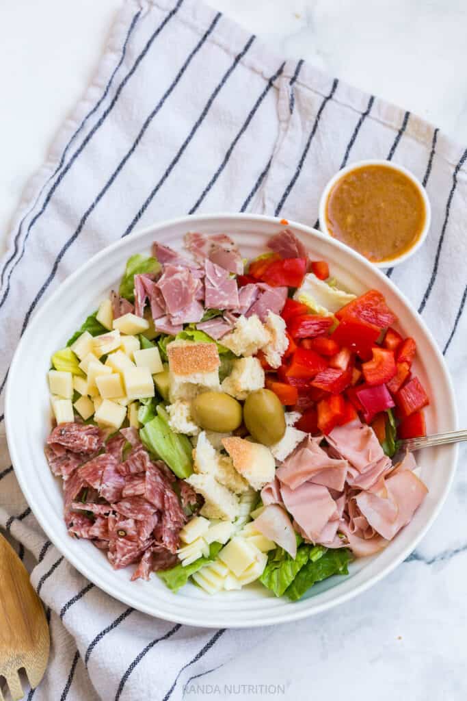 muffuletta salad with deli meat and a olive salad dressing