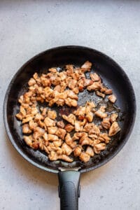 searing chicken thighs in a skillet