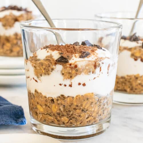 protein tiramisu overnight oats in a glass jar with a spoon