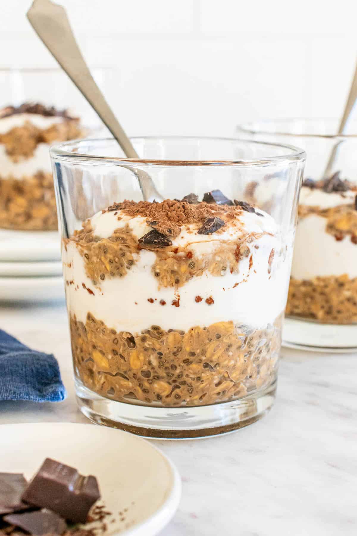 protein tiramisu overnight oats in a glass jar with a spoon