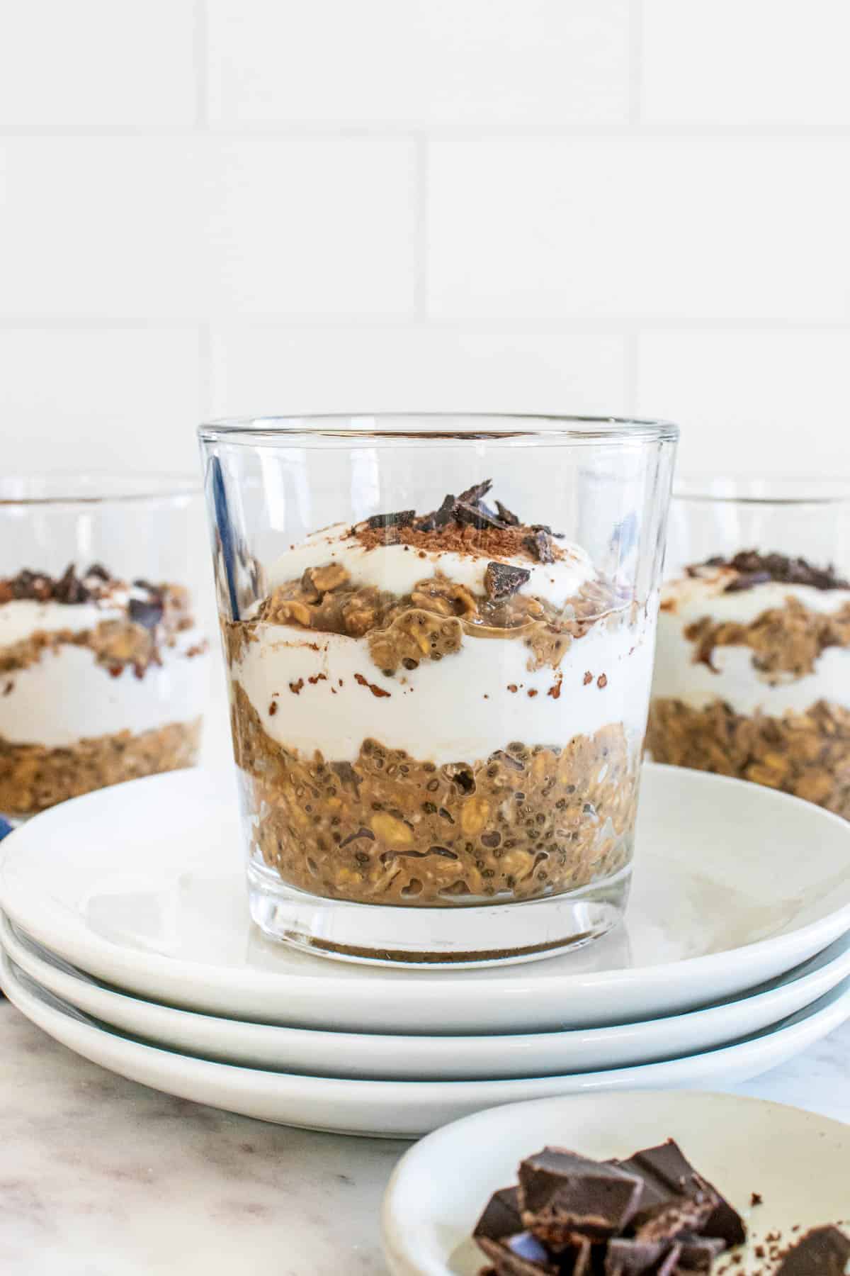 tiramisu protein overnight oats in a glass jar with a greek yogurt layer