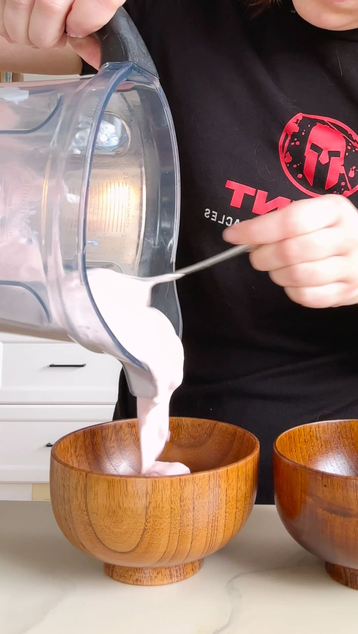 pouring cottage cheese mixture into wooden bowl