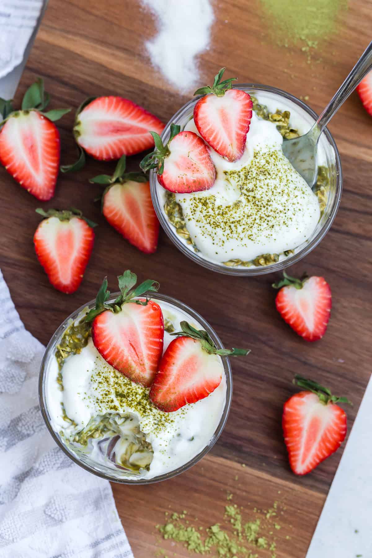 High protein matcha overnight oats topped with Greek yogurt, strawberries, and matcha powder.