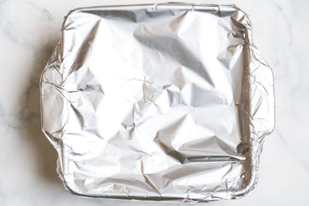 How to Cook Rice In The Oven (White, Brown, or Converted Rice) 5 Baking dish tightly covered with foil for cooking rice in the oven