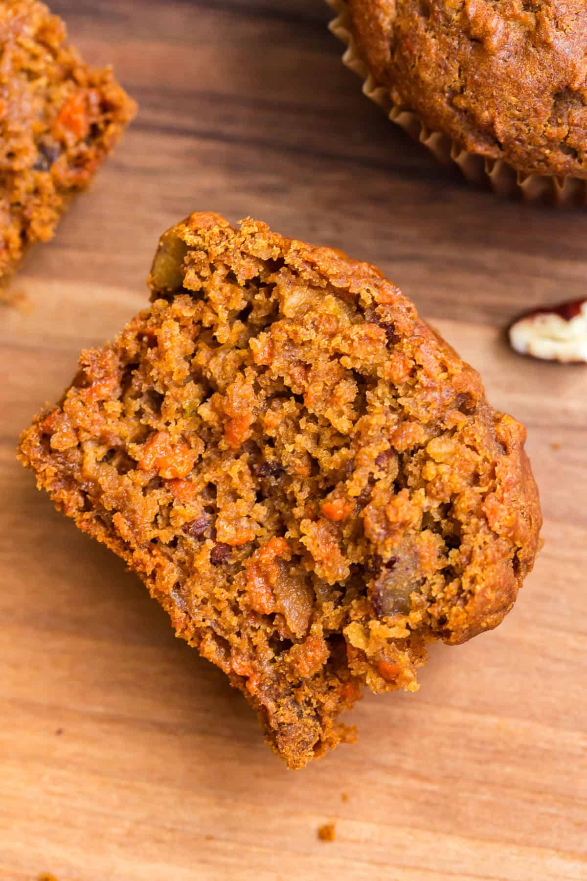 Gluten Free Morning Glory Muffins (Healthy & Moist) 8 Inside of a gluten free morning glory muffin showing a moist crumb with carrots, apple, and nuts.